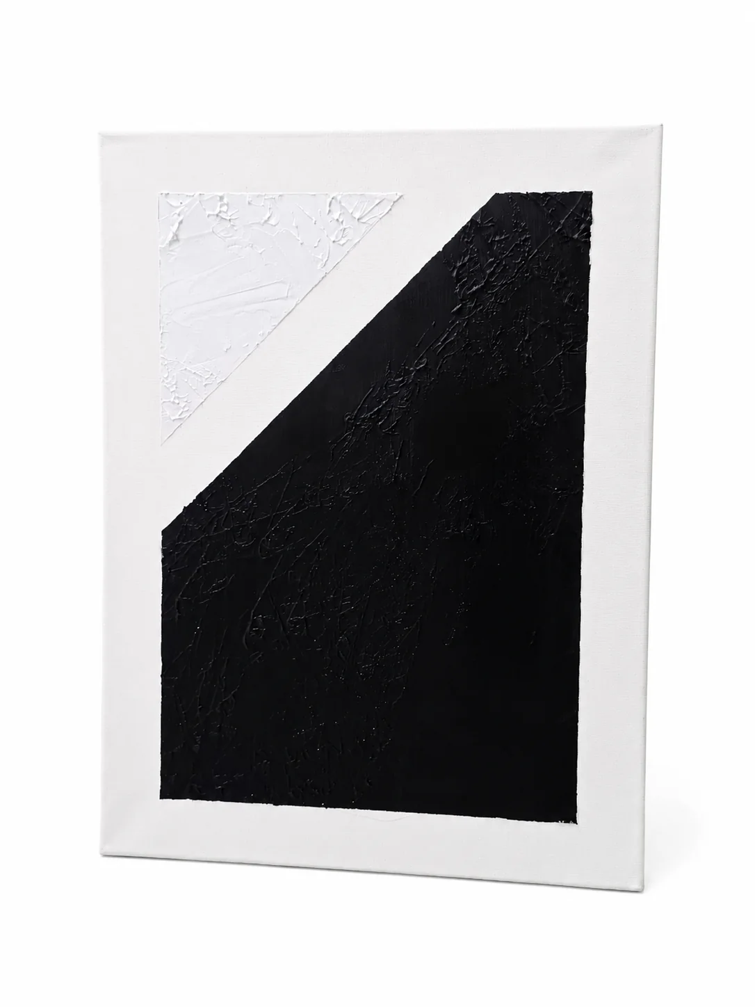 Equilibrium — a small white textured triangle set against a large black form.