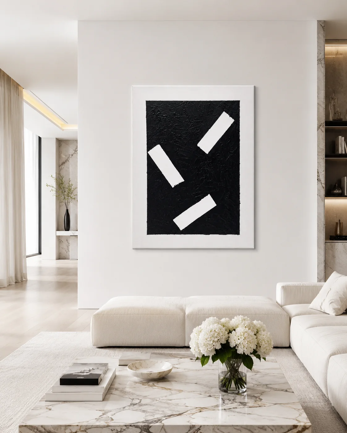 Fragments hanging above a low sofa in a pale living room.