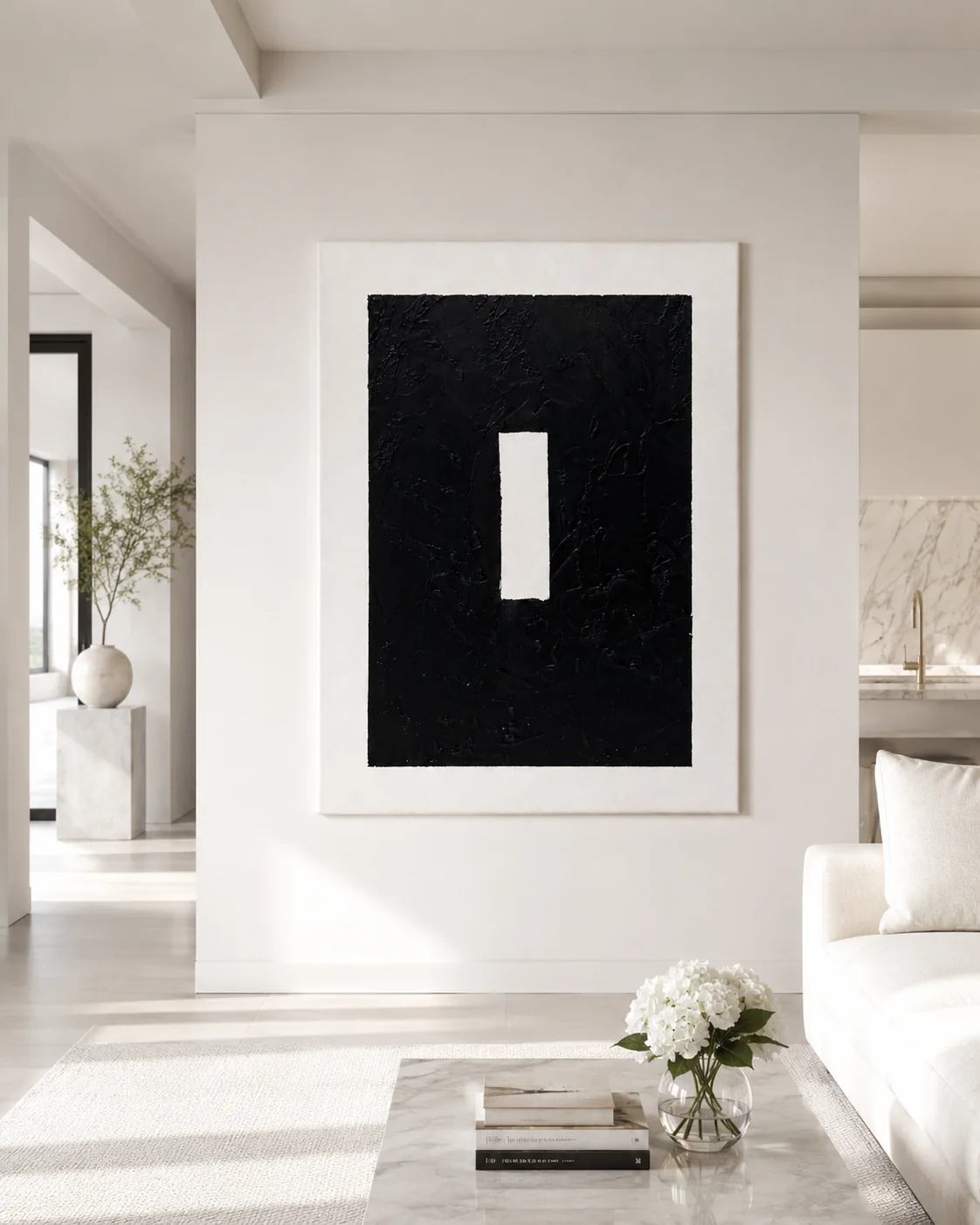 Void hanging on a tall white wall beside a marble kitchen.